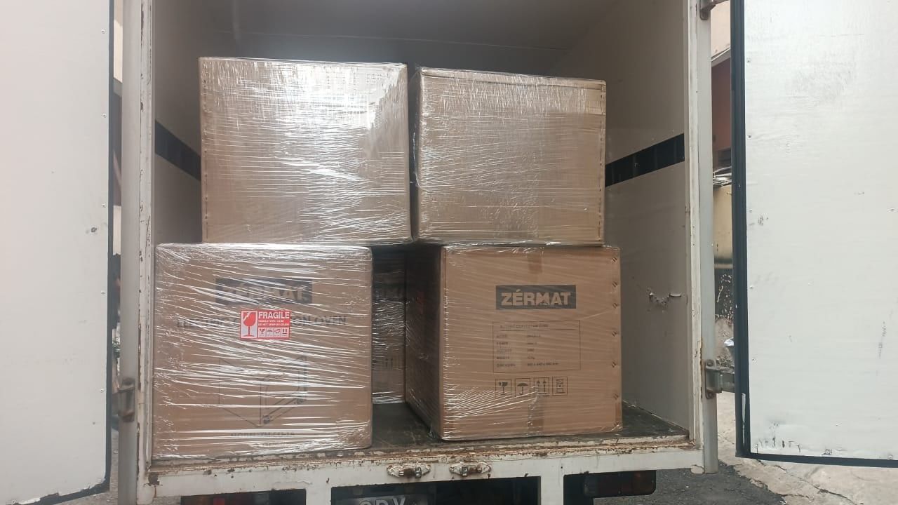 Oven cartons shrink-wrapped & marked FRAGILE, stacked in the lorry
