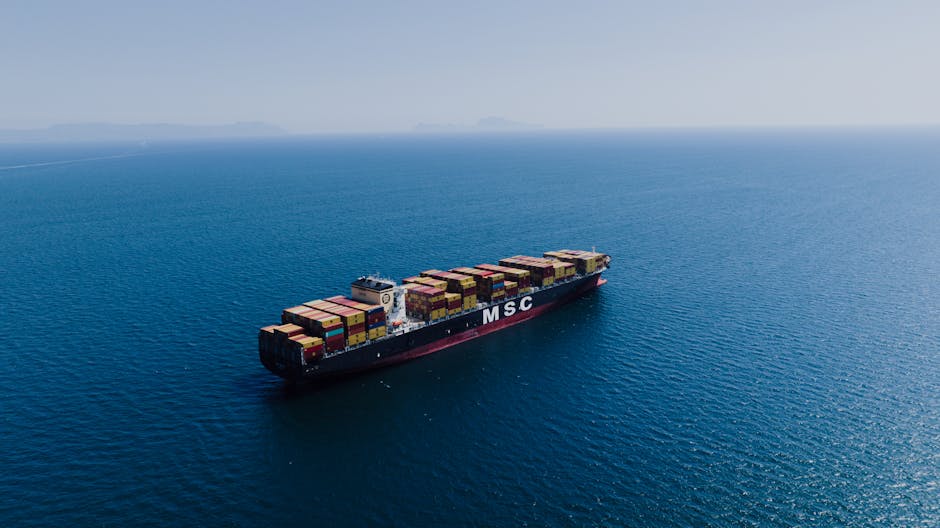 Sea Freight to Sarawak - An aerial shot of a loaded container ship sailing near Naples, Italy under clear blue skies.